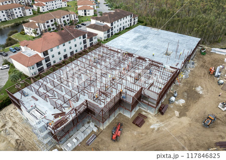 Construction site with many workers and equipment in Fort Myers, Florida. Hard labor employment at commercial development 117846825