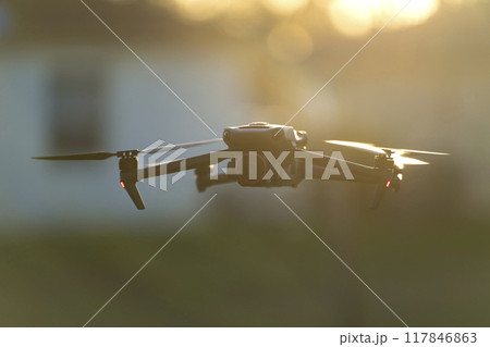 Drone with digital camera and fast rotating propellers flying taking video and pictures Drone with digital camera and fast rotating propellers flying taking video and pictures 117846863