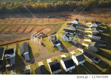 Aerial view of real estate development with tightly located family houses under construction in Carolinas suburban area. Concept of growing american suburbs Aerial view of real estate development with tightly located family houses under construction in Carolinas suburban area. Concept of growing american suburbs 117847090