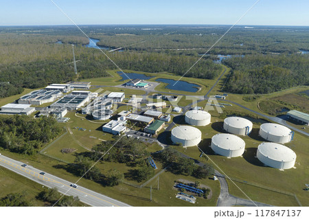 Aerial view of water treatment factory at city wastewater cleaning facility. Purification process of removing undesirable chemicals, suspended solids and gases from contaminated liquid Aerial view of water treatment factory at city wastewater cleaning facility. Purification process of removing undesirable chemicals, suspended solids and gases from contaminated liquid 117847137