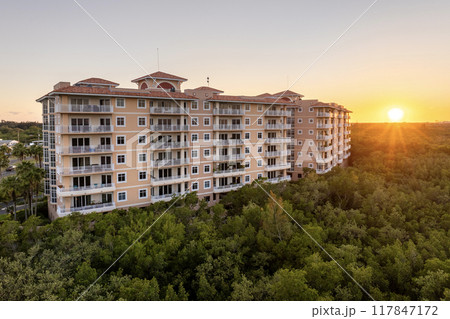 Apartment building with tropical wetlands view in Florida rural area. Family housing in quiet neighborhood. Real estate development in American suburbs Apartment building with tropical wetlands view in Florida rural area. Family housing in quiet neighborhood. Real estate development in American suburbs 117847172