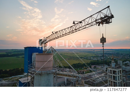 Aerial view of cement factory under construction with high concrete plant structure and tower cranes at industrial production area. Manufacture and global industry concept Aerial view of cement factory under construction with high concrete plant structure and tower cranes at industrial production area. Manufacture and global industry concept 117847277