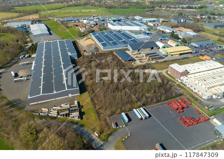 Aerial view of goods warehouses and logistics center in industrial city zone from above Aerial view of goods warehouses and logistics center in industrial city zone from above 117847309