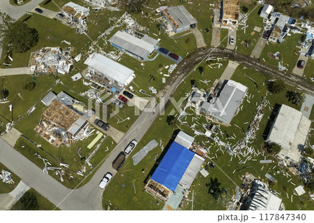 Aerial view of natural disaster consequences in Florida Southwest region. Severely damaged by hurricane Ian mobile homes in residential area 117847340