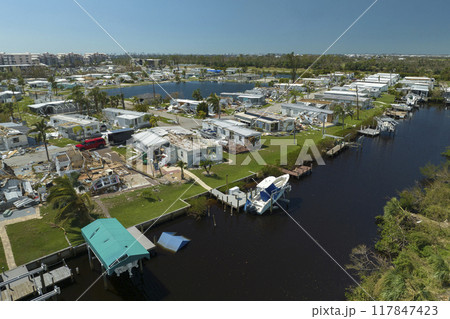Aerial view of badly damaged mobile homes after hurricane Ian swept through residential area in Florida. Aftermath of natural disaster Aerial view of badly damaged mobile homes after hurricane Ian swept through residential area in Florida. Aftermath of natural disaster 117847423