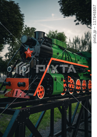 A small model of an old steam locomotive in the city of Baranovichi 117848807