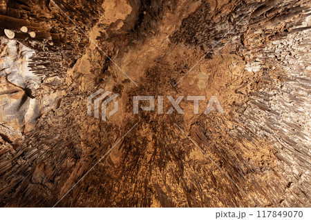 Looking up at the ceiling with stalactites. Natural photo 117849070