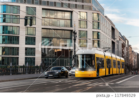 Scenic evening view Weidendammer bridge street and yellow  tram train bridge in Berlin Mitte central district at dusk sunset. Urban european transport commute cityscape Germany scene background 117849329