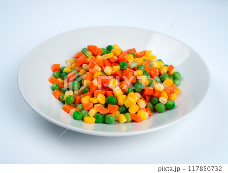 Organic Food. Mixed Vegetables Isolated White Background. Vegetable containing carrots, peas, and corn on white background, Healthy food, Colorful mixed vegetables. Organic Food. Mixed Vegetables Isolated White Background. Vegetable containing carrots, peas, and corn on white background, Healthy food, Colorful mixed vegetables. 117850732