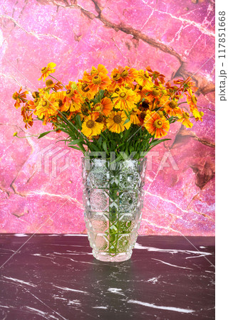 Glass vase with a bouquet of Helenium flowers. Glass vase with a bouquet of Helenium flowers. 117851668