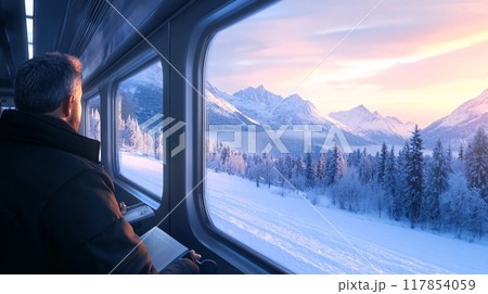 Man Enjoying Scenic Winter Mountain Views from a Train Window at Sunset 117854059