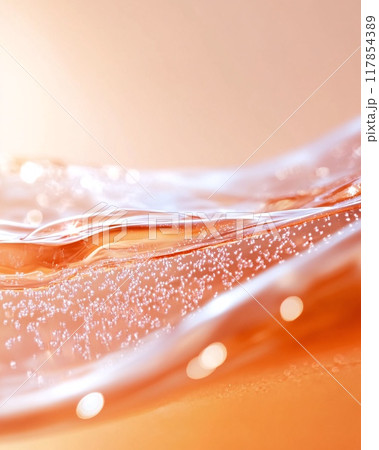 Close-Up of Vibrant Orange Liquid With Bubbles Creating Abstract Patterns 117854389