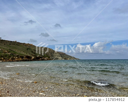 Beautiful sandy beach on the Coast of the island of Gozo, Malta. The Mediterranean Sea. 117854912