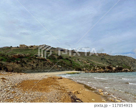 Beautiful sandy beach on the Coast of the island of Gozo, Malta. The Mediterranean Sea. 117854915