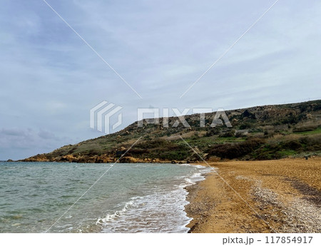 Beautiful sandy beach on the Coast of the island of Gozo, Malta. The Mediterranean Sea. Beautiful sandy beach on the Coast of the island of Gozo, Malta. The Mediterranean Sea. 117854917