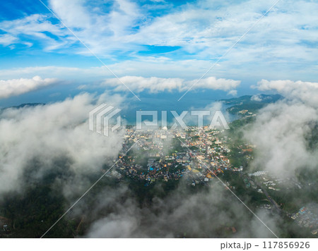 Aerial view of flowing fog waves on mountain tropical rainforest,Bird eye view image over the clouds Amazing nature background with clouds and mountain peaks in Thailand Aerial view of flowing fog waves on mountain tropical rainforest,Bird eye view image over the clouds Amazing nature background with clouds and mountain peaks in Thailand 117856926