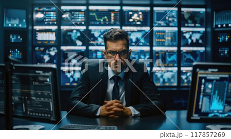 A cybersecurity expert in a sleek, modern office setting, analyzing digital data on multiple screens 117857269