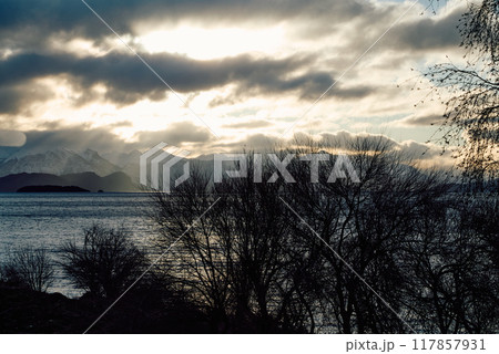 Dramatic sunset over the lake and trees 117857931
