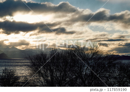 Dramatic sunset over the lake and trees 117859190