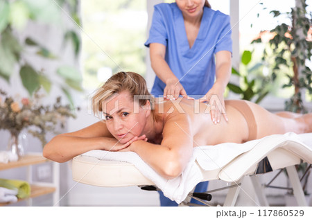 Woman get course of physiotherapy Woman get course of physiotherapy 117860529