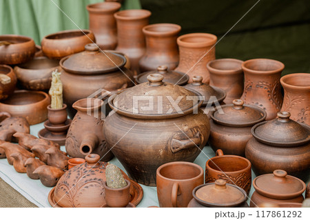 Rows of traditional ethnic pottery in the assortment at the fair outdoor, close-up, selective focus. Rows of traditional ethnic pottery in the assortment at the fair outdoor, close-up, selective focus. 117861292