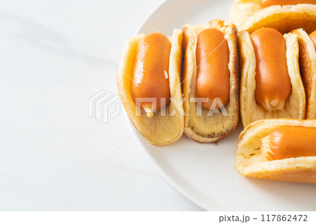 flat pancake roll with sausage 117862472
