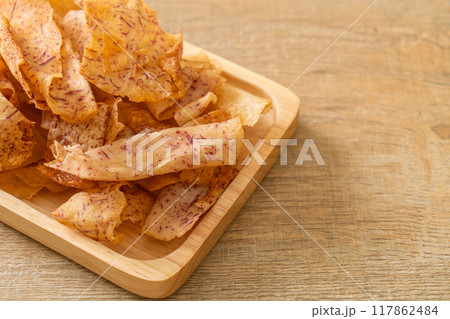 Taro Chips - fried or baked sliced taro 117862484