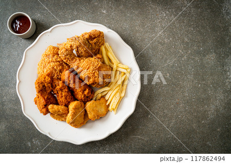 fried chicken with french fries and nuggets on plate 117862494