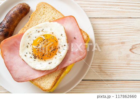bread toasted cheese topped ham and fried egg with pork sausage bread toasted cheese topped ham and fried egg with pork sausage 117862660