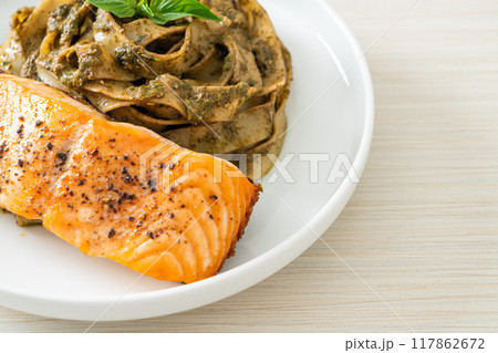 pesto fettuccine spaghetti pasta with grilled salmon fillet pesto fettuccine spaghetti pasta with grilled salmon fillet 117862672