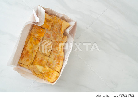 roti with egg and sweetened condensed milk roti with egg and sweetened condensed milk 117862762