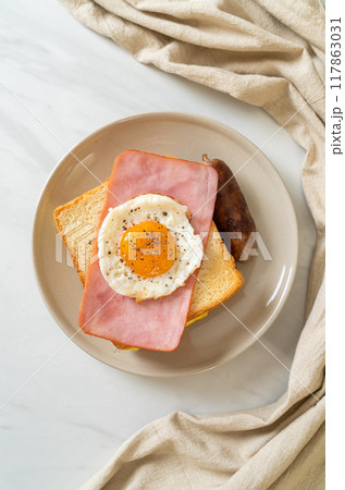 bread toasted cheese topped ham and fried egg with pork sausage bread toasted cheese topped ham and fried egg with pork sausage 117863031