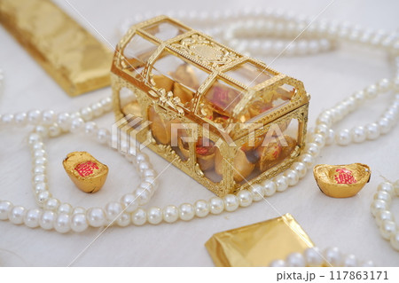 golden box with chocolate and gold chocolate bars on a white background. chinese new year golden box with chocolate and gold chocolate bars on a white background. chinese new year 117863171