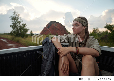 Traveler riding in body of pickup truck Traveler riding in body of pickup truck 117865475
