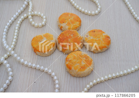peanut cookies with white pearls on a wooden background, top view peanut cookies with white pearls on a wooden background, top view 117866205