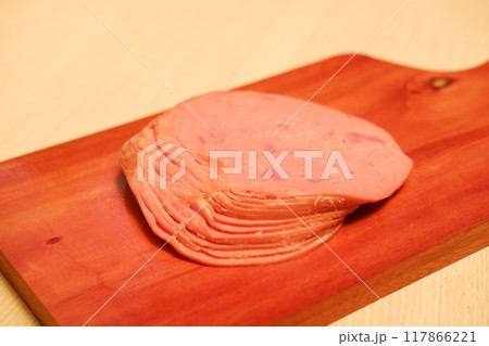 Slices of ham on a cutting board, closeup of photo 117866221
