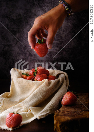 red ripe strawberries on a dark background red ripe strawberries on a dark background 117868519