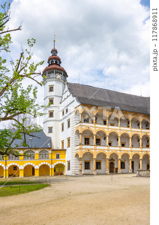 Charming courtyard of Velke Losiny Chateau in Czechia, surrounded by historic architecture and green trees under a partly cloudy sky on a pleasant day. Charming courtyard of Velke Losiny Chateau in Czechia, surrounded by historic architecture and green trees under a partly cloudy sky on a pleasant day. 117868911