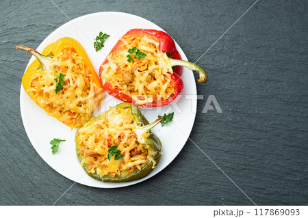 Baked stuffed pepper ( paprika ) with rice , carrot and meat . Top view on rustic background Baked stuffed pepper ( paprika ) with rice , carrot and meat . Top view on rustic background 117869093