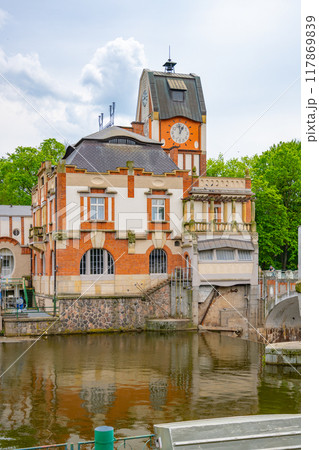The Hucak hydroelectric power station in Hradec Kralove showcases its stunning Art Nouveau architecture, reflecting the historical significance of early 20th-century engineering by the river's edge. 117869839