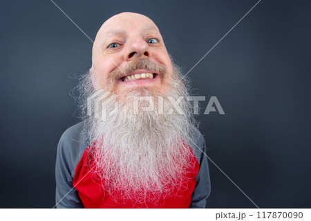 Elderly man with a long, white beard smiling widely against a dark background Elderly man with a long, white beard smiling widely against a dark background 117870090
