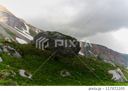 A Mountain Boulder Under Cloudy Skies 117872205