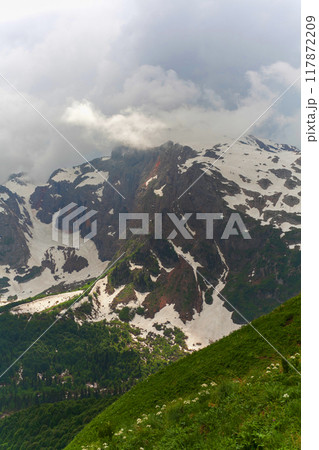 Majestic Mountain Peak Emerging From the Clouds 117872209