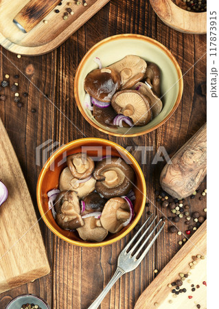 Salted pickled mushrooms. 117873915
