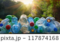 Empty used plastic bottles on background of nature in sun rays 117874168