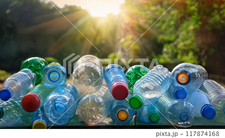 Empty used plastic bottles on background of nature in sun rays Empty used plastic bottles on background of nature in sun rays 117874168