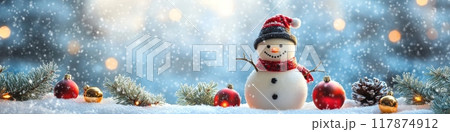 Snowman standing in snow with christmas ornaments and falling snow 117874912