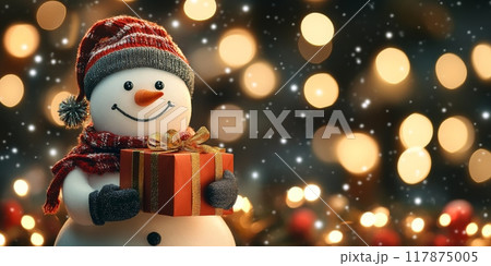 Smiling snowman holding christmas gift with golden bokeh lights 117875005