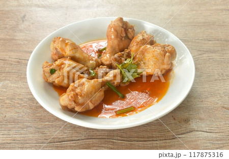 steamed chicken drumstick with sweet red gravy sauce on plate  117875316