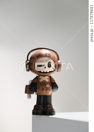 Figurine of skull-faced character in attire. 117876681